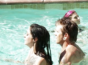 Two girls and a guy have some hardcore fun in the pool