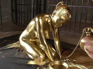 Hot slave girl painted in gold loves playing with a throbbing dick