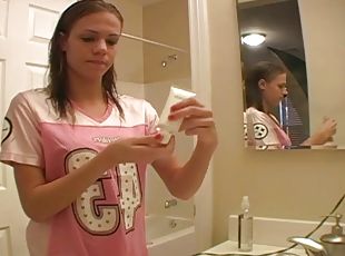 Dashing teen fairy applies her make up in front of the mirror