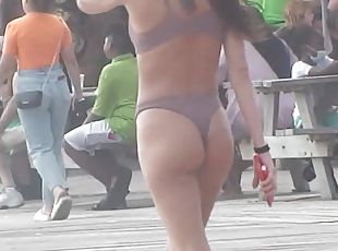 Amazing fit girl with bubble ass takes a walk to the beach