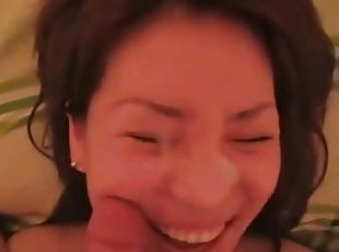 A pretty korean girl is filmed sucking a small cock and taking its cum all over her face