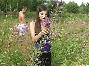 Romantic sex in a field of flowers with a cute brunette teen