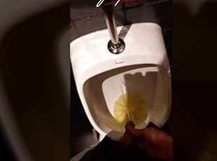 This handsome boy pisses pee in a public urinal in a crowded restaurant. Jon Arteen gay porn video