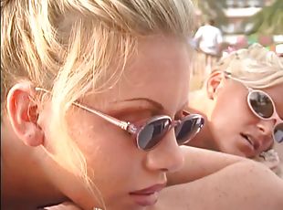 A guy has a threesome with two hot chicks on a public beach