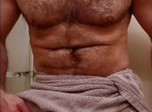 MUSCLE BEAR FLEXING IN TOWEL BEFORE SHOWER