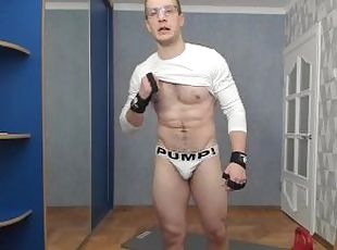 Russian guy lifts a dumbbell in sexy underwear