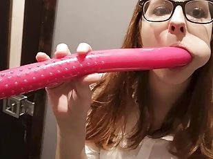 Lady with glasses plays with a dildo.