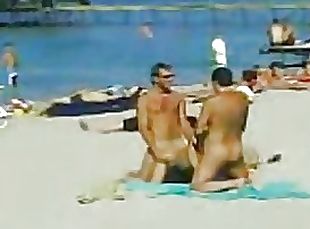 Two Guys and One Sexy Babe Have a Hot Threesome on a Nude Beach