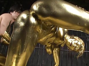 She is covered in gold paint then she gets fucked by a golden guy