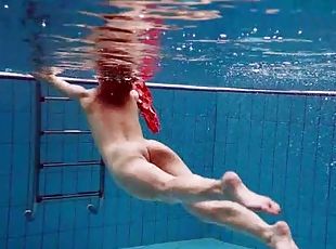 Teen swimming in her red satin prom dress