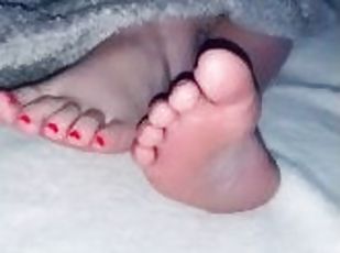 She shows me her sexy meaty feet with pink nails while watching TV