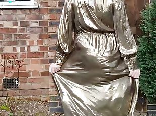 Sissy crossdresser outdoors in gold metallic shiny dress