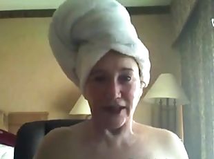 A fresh old woman teases the camera after a shower