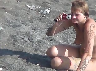 MILF nudist is getting naked on the beach