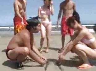 Japanese girls wrestling on the beach